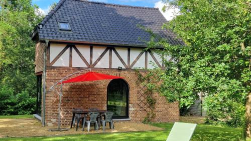 a house with a table and chairs in front of it at Le Tiyou in Spa