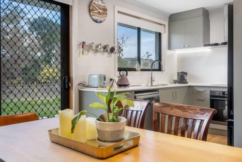 una cocina con una mesa con una maceta. en Peaceful Beachside Home, en Sandford