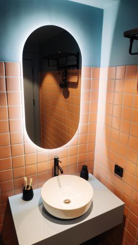 a bathroom with a sink and a mirror at BAMBOO GARDEN in Kobuleti