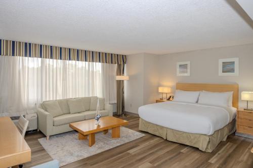 a hotel room with a bed and a couch at Solomons Inn Resort and Marina in Solomons