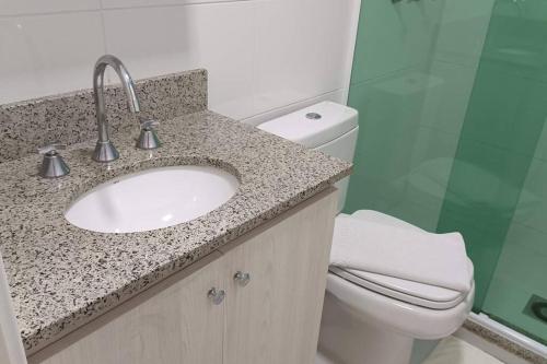 a bathroom with a sink and a toilet at Espaço especial IX in Curitiba