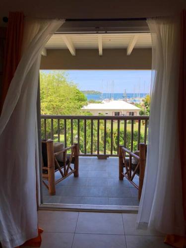 a room with a balcony with a view of the water at Falmouth Sea View Loft in Falmouth