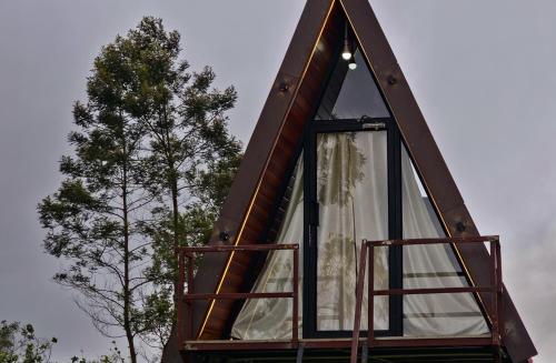 a tree house with a window on the side of it at Wrongturnclub hilltop adventure stay in Kūkkāl