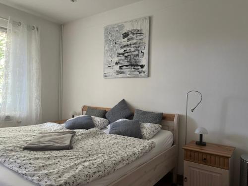 a bedroom with a bed with pillows on it at Landhaus am See Flecken Zechlin in Rheinsberg
