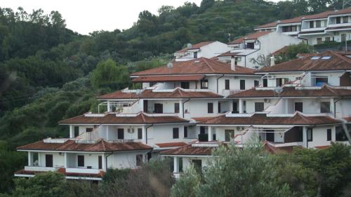 a group of houses with red roofs on a hill at Residence l'Ogliastro in Petrizzi