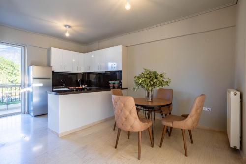 a kitchen and dining room with a table and chairs at Villy's Comfort Zone Apartments in Kalamata