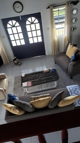 a living room with a couch and a table with pillows at Le Vie in Becke Moui