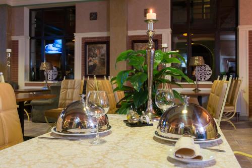 a table with plates and glasses on top of it at Green Villa in Hora