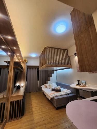 a hotel room with a bed and a staircase at Nordic Rsquare Manila - with Pool Access in Manila