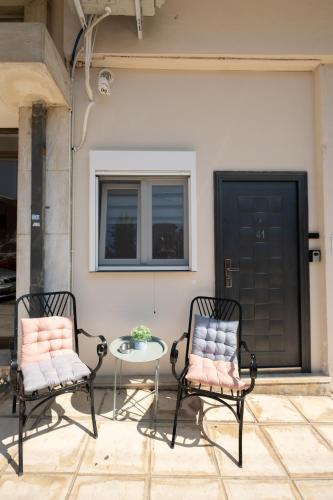 two chairs and a table on a patio at Athanias Studio in Drama