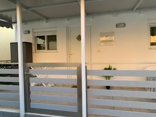a front door of a house with a fence at SERENITY House in Faliraki