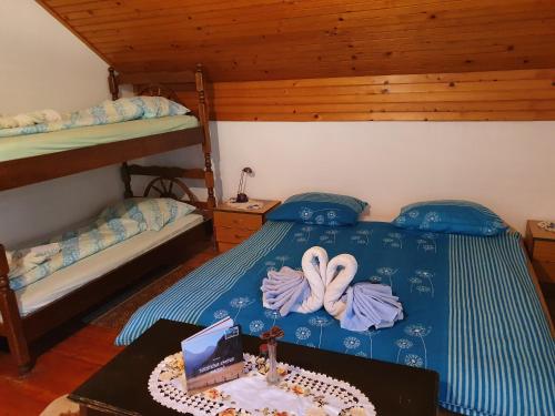 a bedroom with two twin beds and a table with a laptop at Farm stay Majdač in Solčava