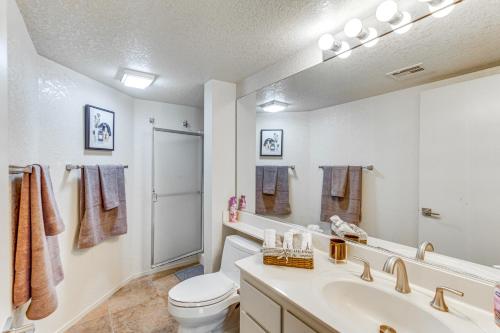 a bathroom with a sink and a toilet and a mirror at Golf, Hike and Relax Cathedral City Condo in Cathedral City