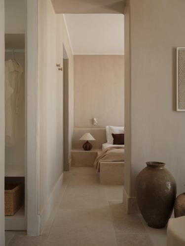 a hallway leading to a living room with a vase at Akria Seaside Suites in Naousa
