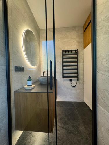 a bathroom with a sink and a mirror at Lavender Resort in Molėtai
