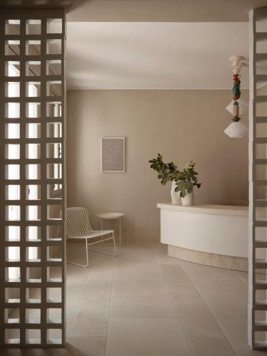 a room with a door and a table and a chair at Akria Seaside Suites in Naousa
