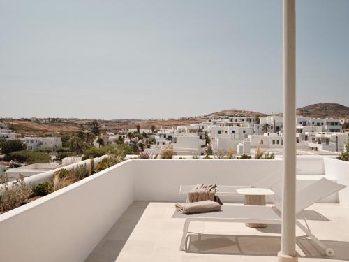 a white balcony with a view of the city at Akria Seaside Suites in Naousa
