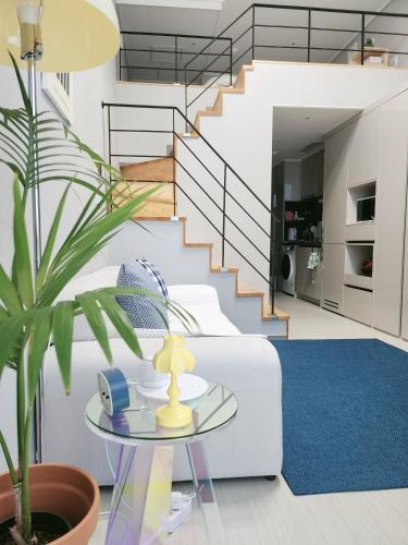 a living room with a white couch and a blue rug at 코아루 시티 in Yeosu