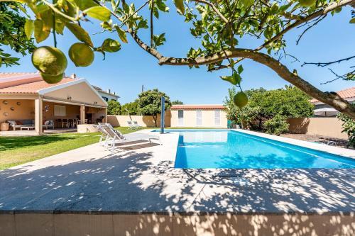 a swimming pool in the backyard of a house at Villa Laranja-Limao in Azeitao