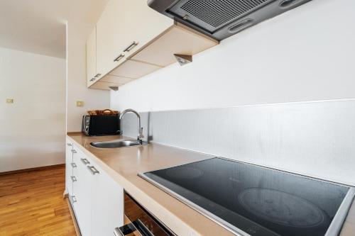 a kitchen with a sink and a counter top at Blue Horison Apartments by In Property in Pržno