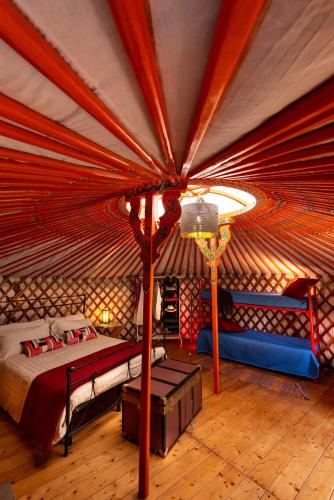 a bedroom with a bed in a yurt at Yurte in Langa in Bosia