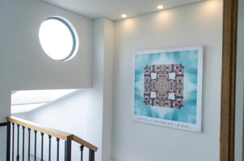 a hallway with a staircase with a picture on the wall at Hotel Camino de la Sal in Zipaquirá
