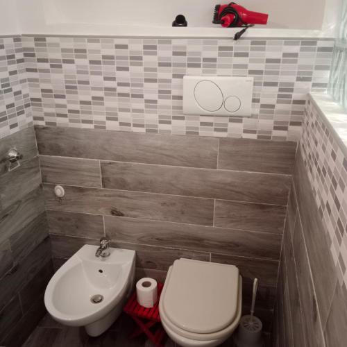 a bathroom with a toilet and a sink at Casa Vacanza Altamura in Altamura