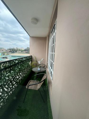 a balcony with a table and chairs on a building at The O Apartment in Ongata Rongai 