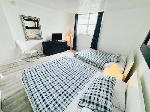 a bedroom with two beds and a mirror at Miami Hollywood Condo With Pool and Partial Ocean View 003-21mar in Hollywood