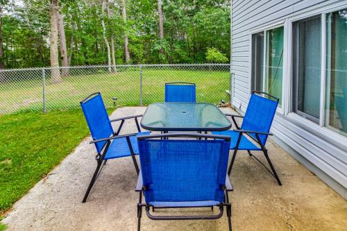 a table and four chairs sitting on a patio at Lakefront Minnesota Home with Deck, Dock and Fire Pit in Park Rapids