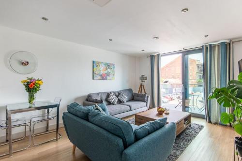 a living room with a couch and a table at Beautiful 1 Bedroom Apartment with parking in Gloucester Docks in Gloucester