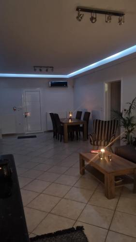 a living room with a table and chairs at Blessed view in Keratea