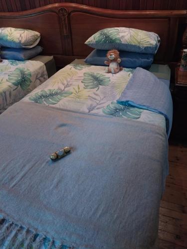 a teddy bear sitting on top of a bed at De La Grace in Potchefstroom