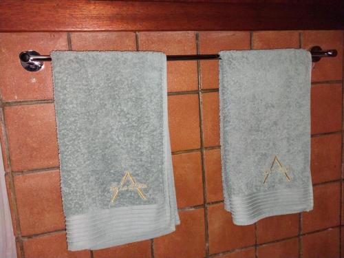 two towels hanging on a rack in a bathroom at De La Grace in Potchefstroom