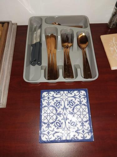 a tray with cutlery on a wooden table at De La Grace in Potchefstroom