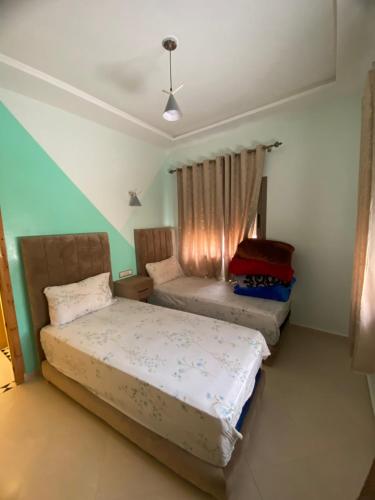 a bedroom with two beds and a window at مولاي يعقوب in Fès