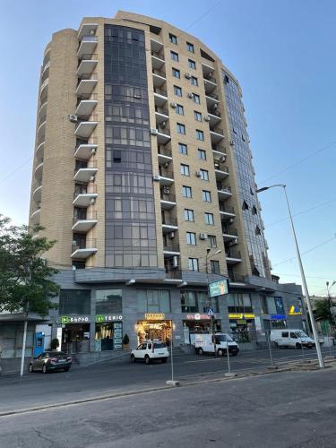 a large building with cars parked in front of it at Apartment in centre of Yerevan in Yerevan
