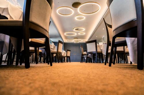 a row of chairs and tables in a room at Hotel Haberkamp in Achim