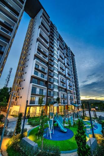 a large apartment building with a playground in front of it at Super Comfort 2R2B Luxury Seaview Sandakan in Sandakan