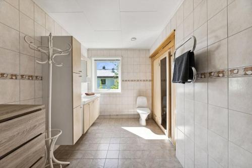 a bathroom with a sink and a toilet in a room at Villa Valentina by Arctic Prive - Northern Lights Villa with Sauna & Fjord View in Alta in Alta