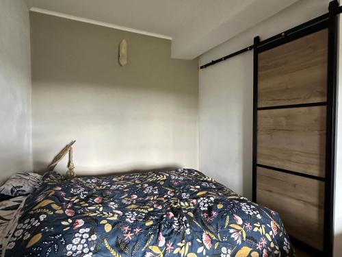 a bedroom with a bed and a wooden closet at Au Cœur de GENSAC, village de charme dominant la Dordogne in Gensac