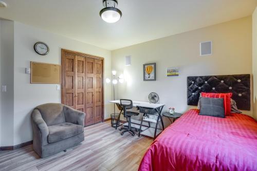 a bedroom with a bed and a desk and a chair at Upscale Laramie Home with Hot Tub and Patio! in Laramie