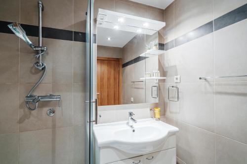 a bathroom with a sink and a shower at Blue Horison Apartments by In Property in Pržno