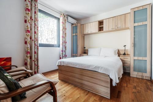 a bedroom with a large bed and a window at Blue Horison Apartments by In Property in Pržno