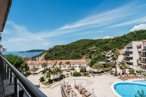 a view from a balcony of a resort with a swimming pool at Blue Horison Apartments by In Property in Pržno