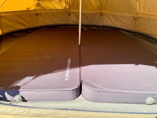 a mattress sitting inside of a tent at Bell tent Boven Duin in 't Horntje