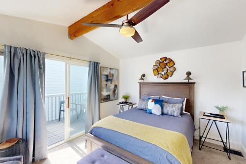 a bedroom with a bed and a balcony at Jewel by the Sea in Cambria