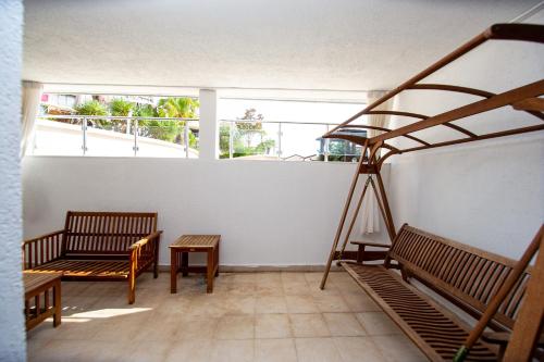 a room with benches and a ladder and windows at Blue Horison Apartments by In Property in Pržno