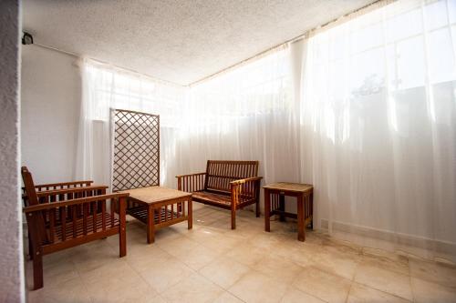 a room with chairs and tables and a window at Blue Horison Apartments by In Property in Pržno