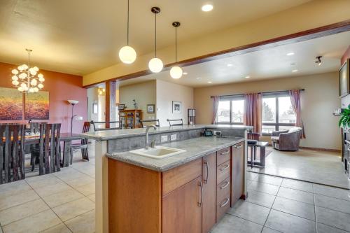 a large kitchen with a sink and a dining room at Upscale Laramie Home with Hot Tub and Patio! in Laramie